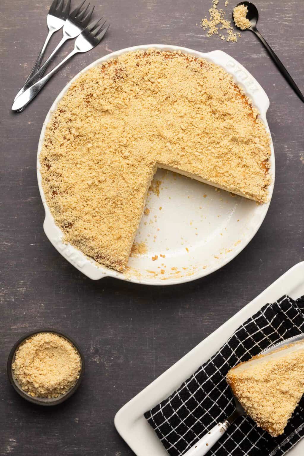 Dairy free cheesecake topped with crushed oreo cookies in a white pie dish. 