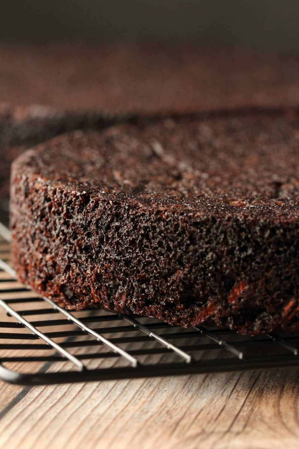 Vegan chocolate zucchini cake layers cooling on a wire cooling rack. 