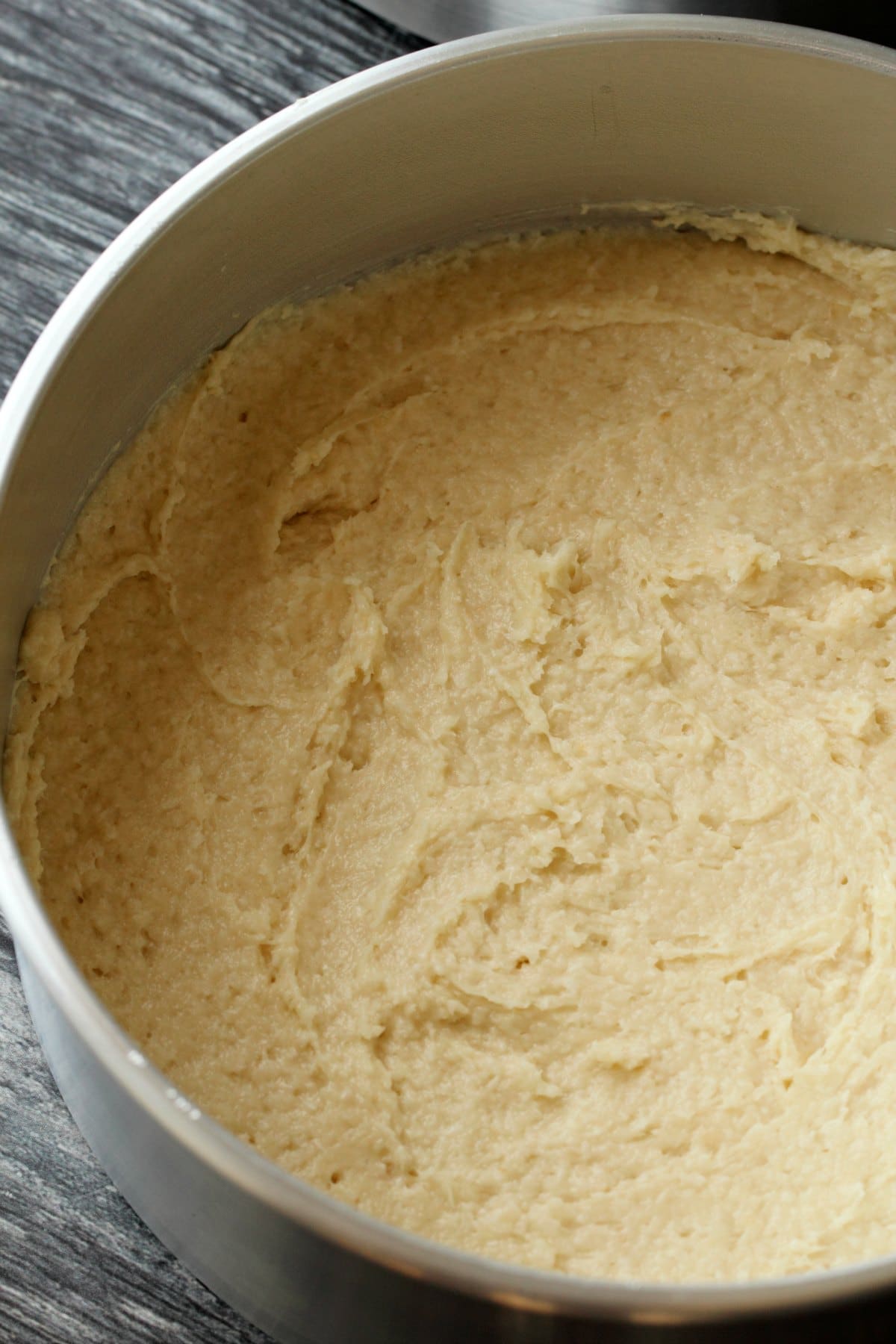 Coconut cake batter in 8-inch round baking pans, ready to go into the oven. 