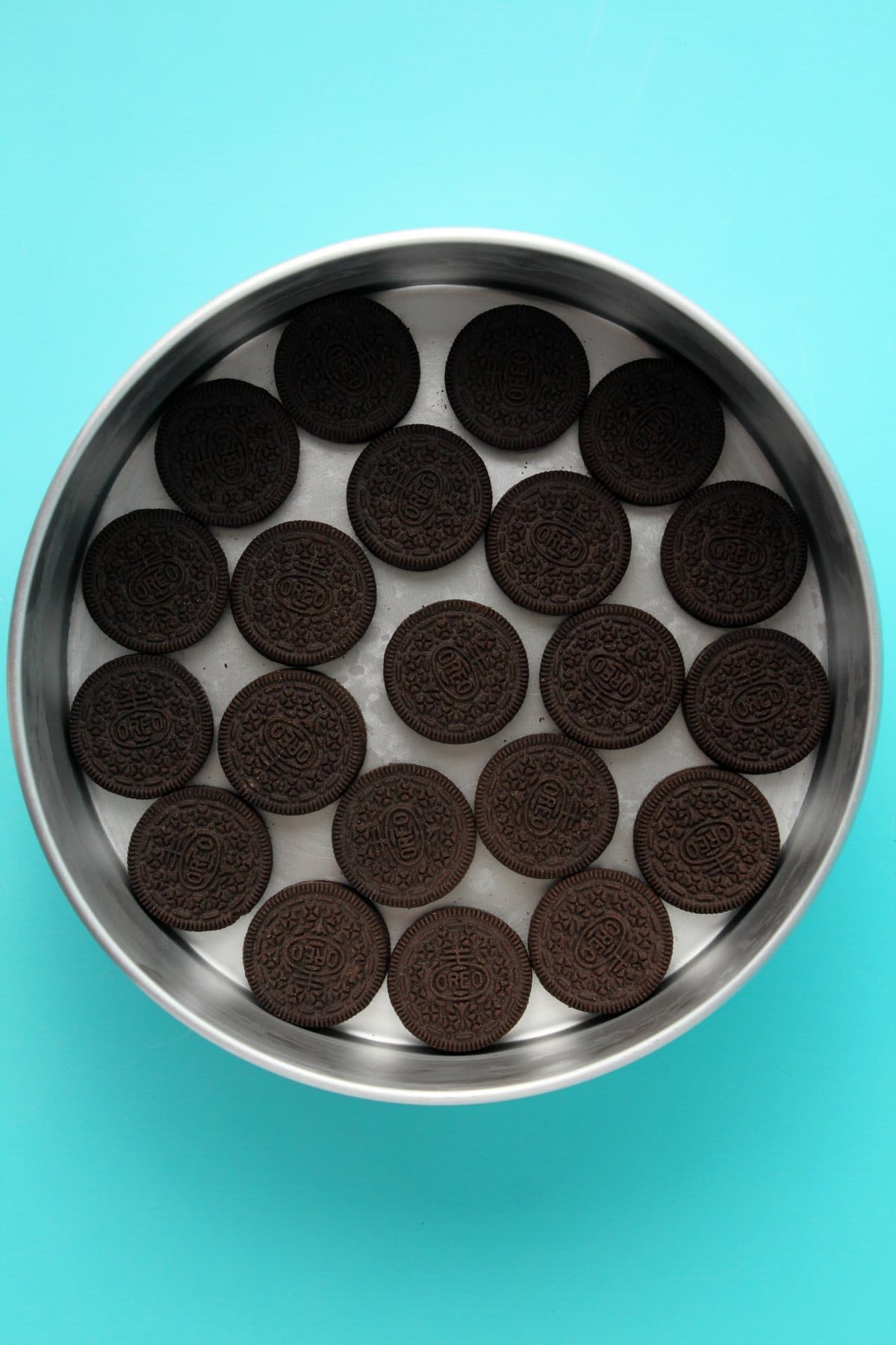 Oreos lining the bottom of a cake pan. 