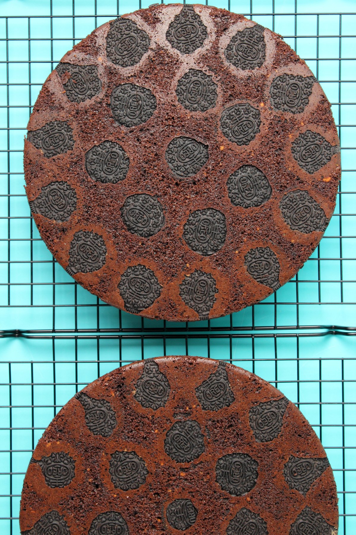 Vegan Oreo cake layers on a wire cooling rack.