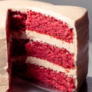 Slice of strawberry cake on a cake lifter.