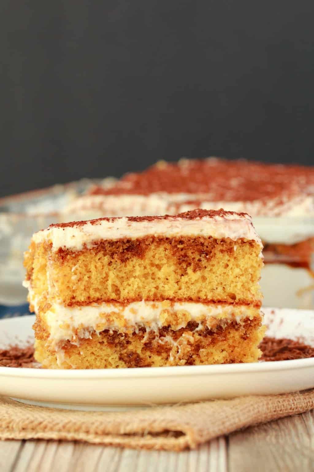 A slice of vegan tiramisu on a white plate.