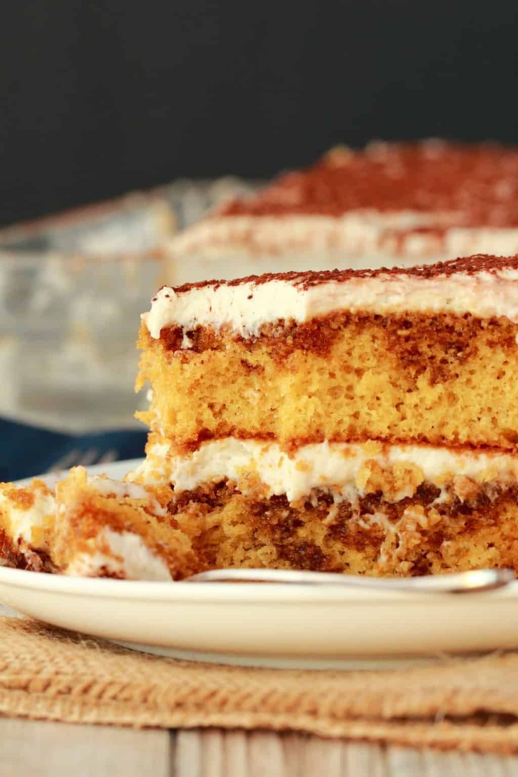 A slice of vegan tiramisu on a white plate.